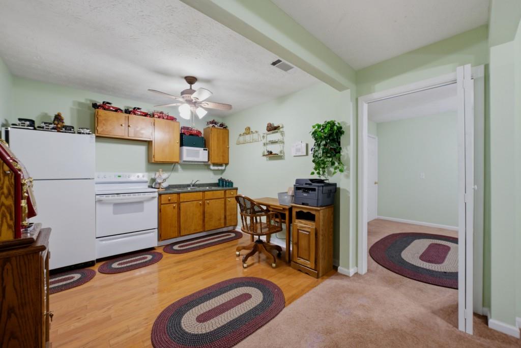 542 Knox Chapel Road Social Circle, GA 30025 - Photo 27 of 52 a workspace with furniture and a kitchen view