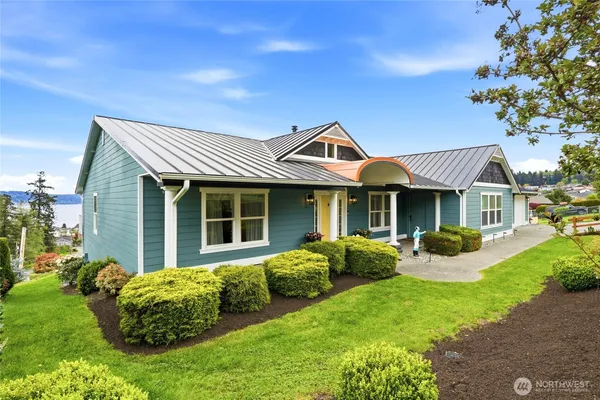 a view of a house with a garden and trees