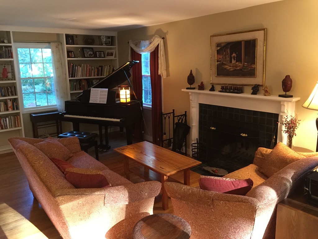 87 Aubinwood Road Amherst, MA 01002 - Photo 7 of 30 a living room with furniture a lamp and a fireplace