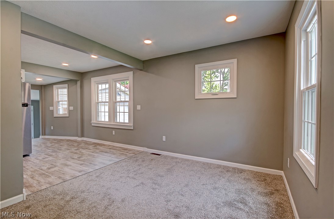 14507 Glencliffe Road Cleveland, OH 44111 - Photo 9 of 31 Empty room featuring plenty of natural light and carpet flooring