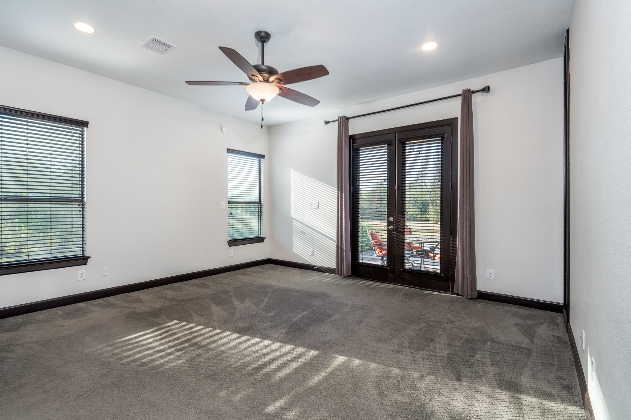12748 Roy Road Pearland, TX 77581 - Photo 31 of 50 Primary bedroom on the first floor has walk-out French door access to the covered patio and pool area.