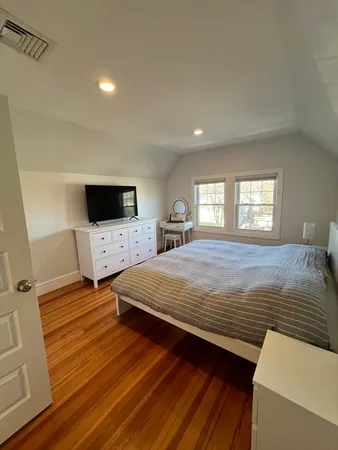 a bedroom with a bed and a flat screen tv