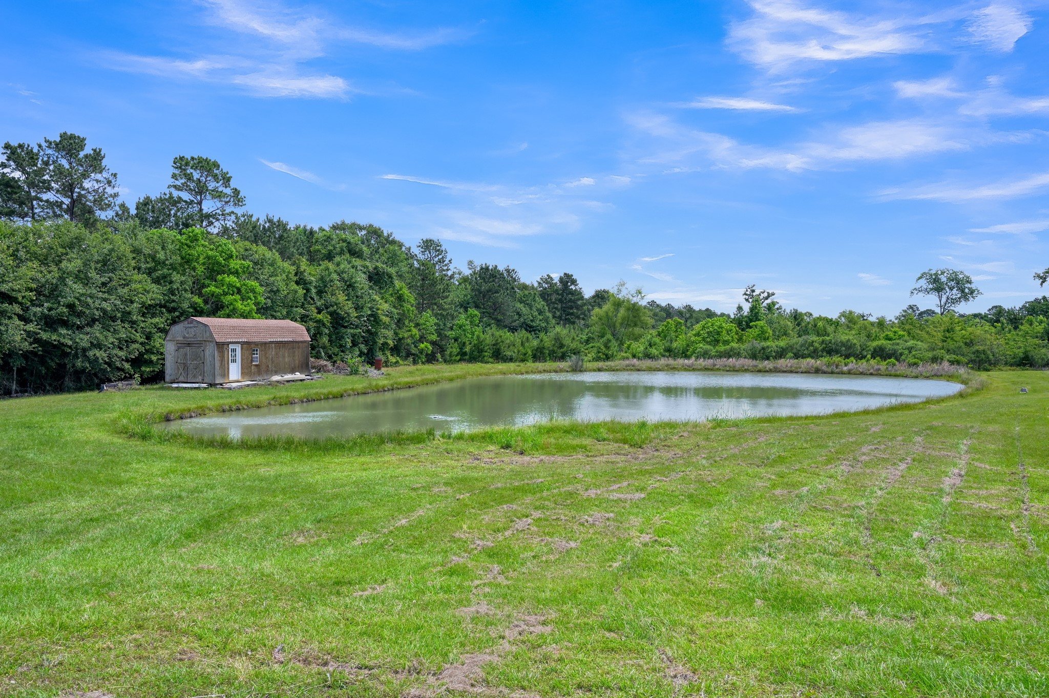 144 Wood Farm Road Huntsville, TX 77320 - Photo 33 of 35 a view of a lake with a house in the background