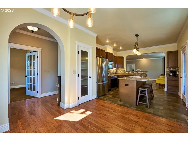 a open kitchen with kitchen island a sink stove and refrigerator