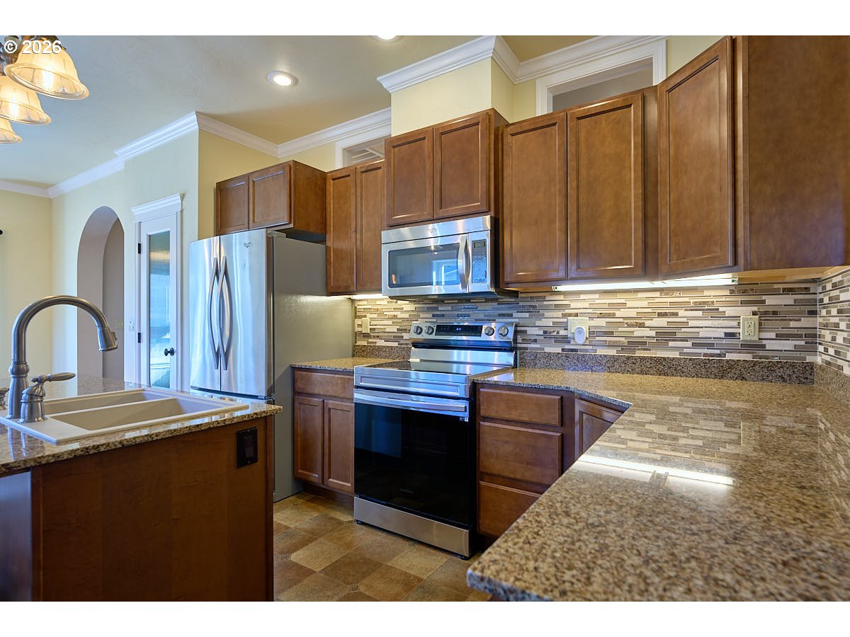 612 North Mill Street Joseph, OR 97846 - Photo 7 of 32 a kitchen with stainless steel appliances granite countertop a stove a sink dishwasher and a refrigerator