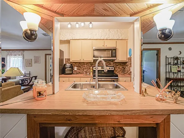 a kitchen with stainless steel appliances a stove microwave and refrigerator