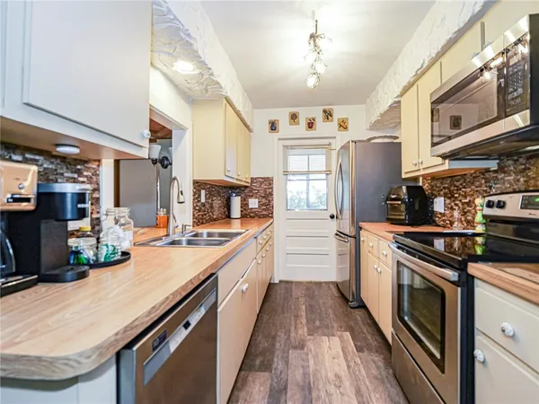 a kitchen with stainless steel appliances granite countertop a stove and a sink