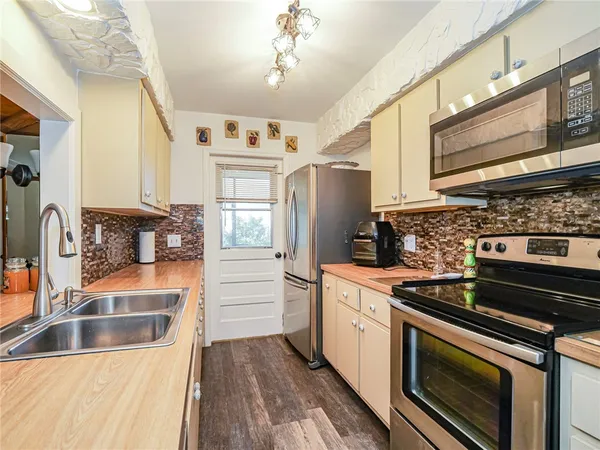 a kitchen with stainless steel appliances granite countertop a stove and a sink