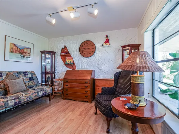 a living room with furniture and a chair