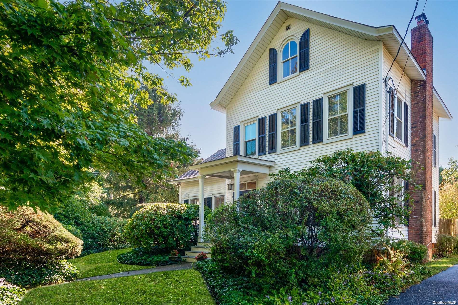 226 Main Street Cold Spring Harbor, NY 11724 - Photo 1 of 1 a front view of a house with a yard and potted plants