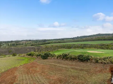 an aerial view of a golf course with parking space