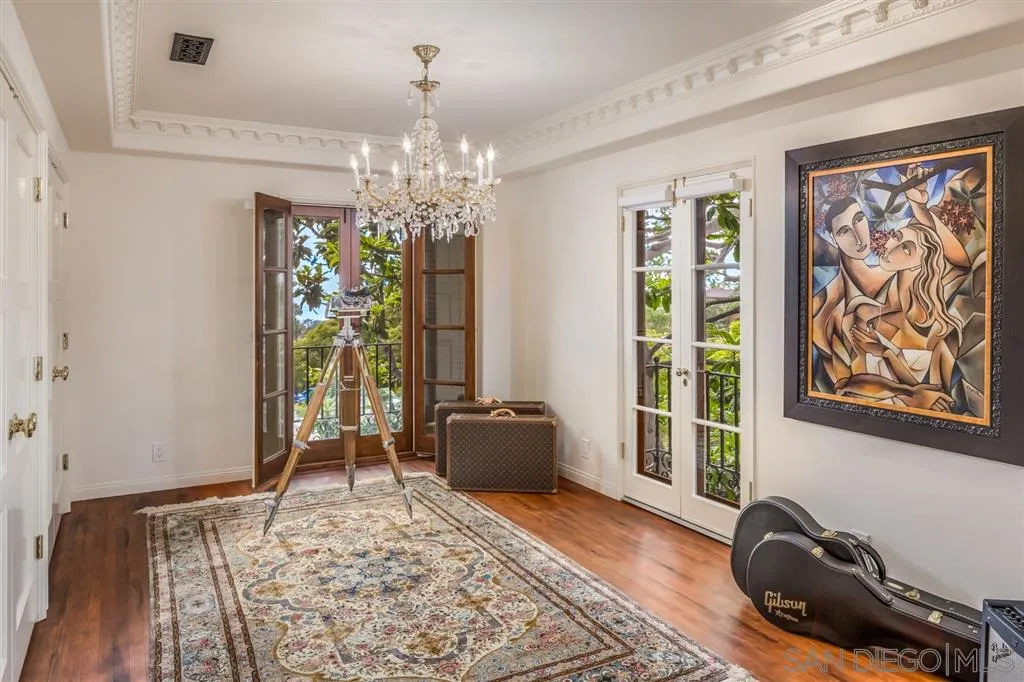 901 Highland Avenue Del Mar, CA 92014 - Photo 13 of 25 a bedroom with furniture and a chandelier