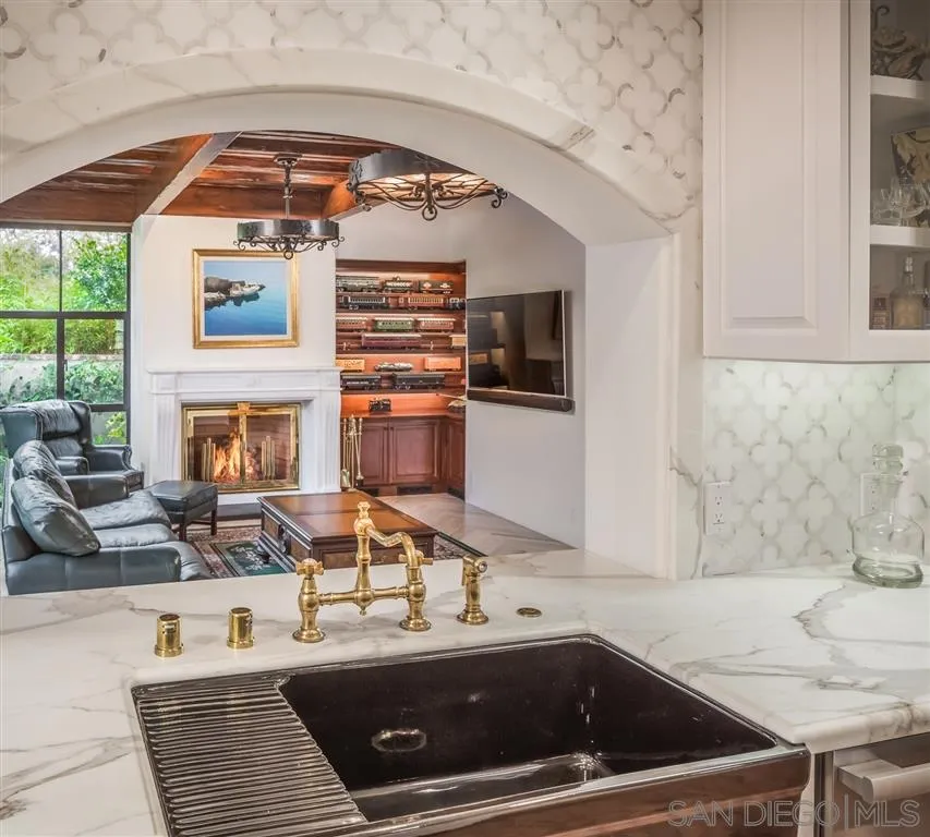 901 Highland Avenue Del Mar, CA 92014 - Photo 7 of 25 a kitchen with a sink and a stove top oven