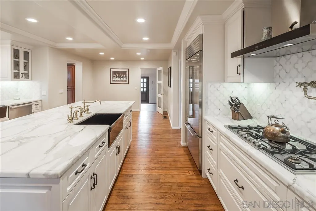 901 Highland Avenue Del Mar, CA 92014 - Photo 8 of 25 a large white kitchen with stainless steel appliances