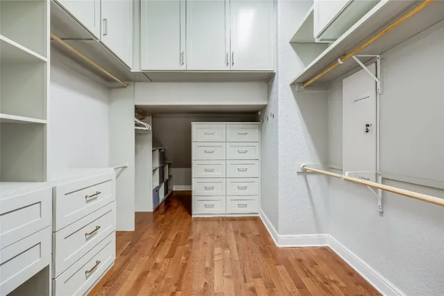 a view of walk in closet with empty racks