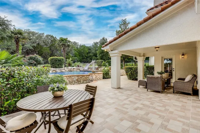 a view of a patio with table and chairs and potted plants