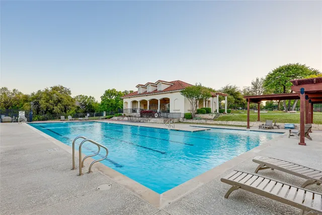 a view of a swimming pool with a lounge chair