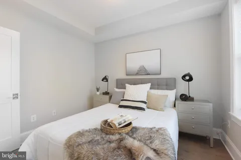 a bedroom with a bed and lamp