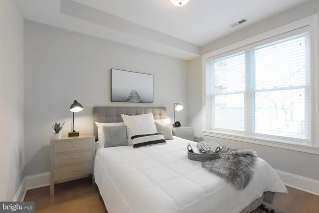 a bedroom with a bed and a window