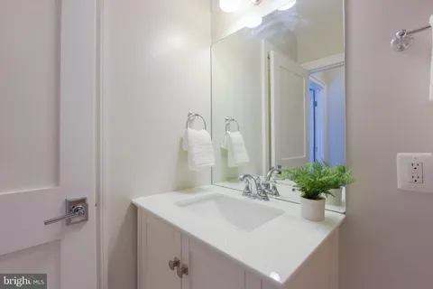a bathroom with a sink a vanity and a mirror