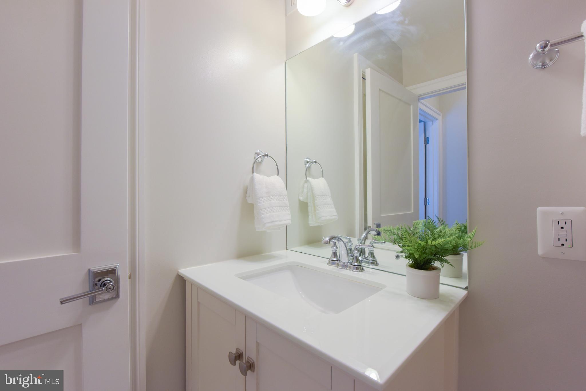 3921 Fulton Street Northwest, Unit 3 Washington, DC 20007 - Photo 18 of 24 a bathroom with a sink a vanity and a mirror
