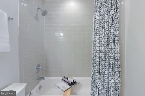 a bathroom with a shower toilet and a sink
