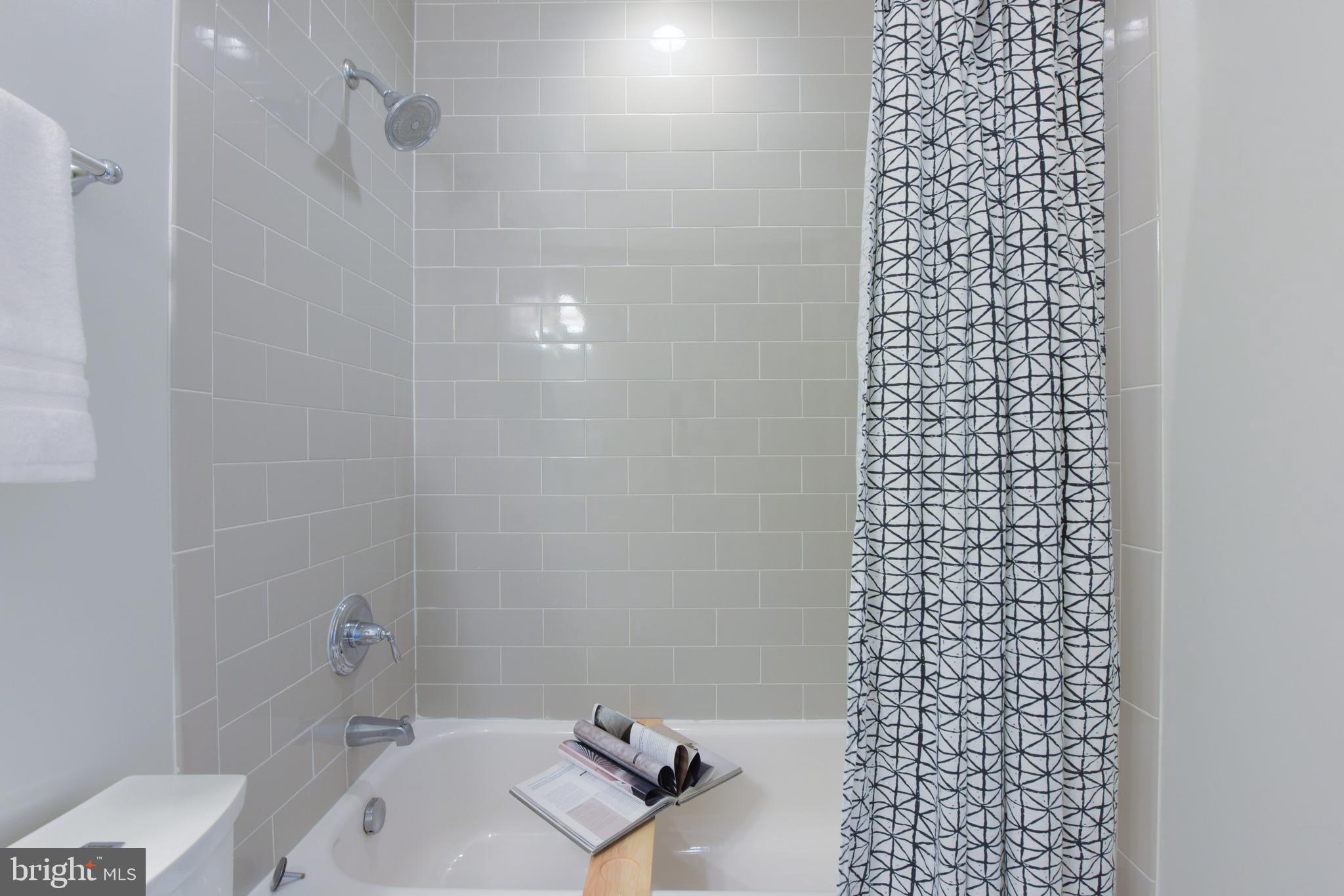 3921 Fulton Street Northwest, Unit 3 Washington, DC 20007 - Photo 19 of 24 a bathroom with a shower toilet and a sink