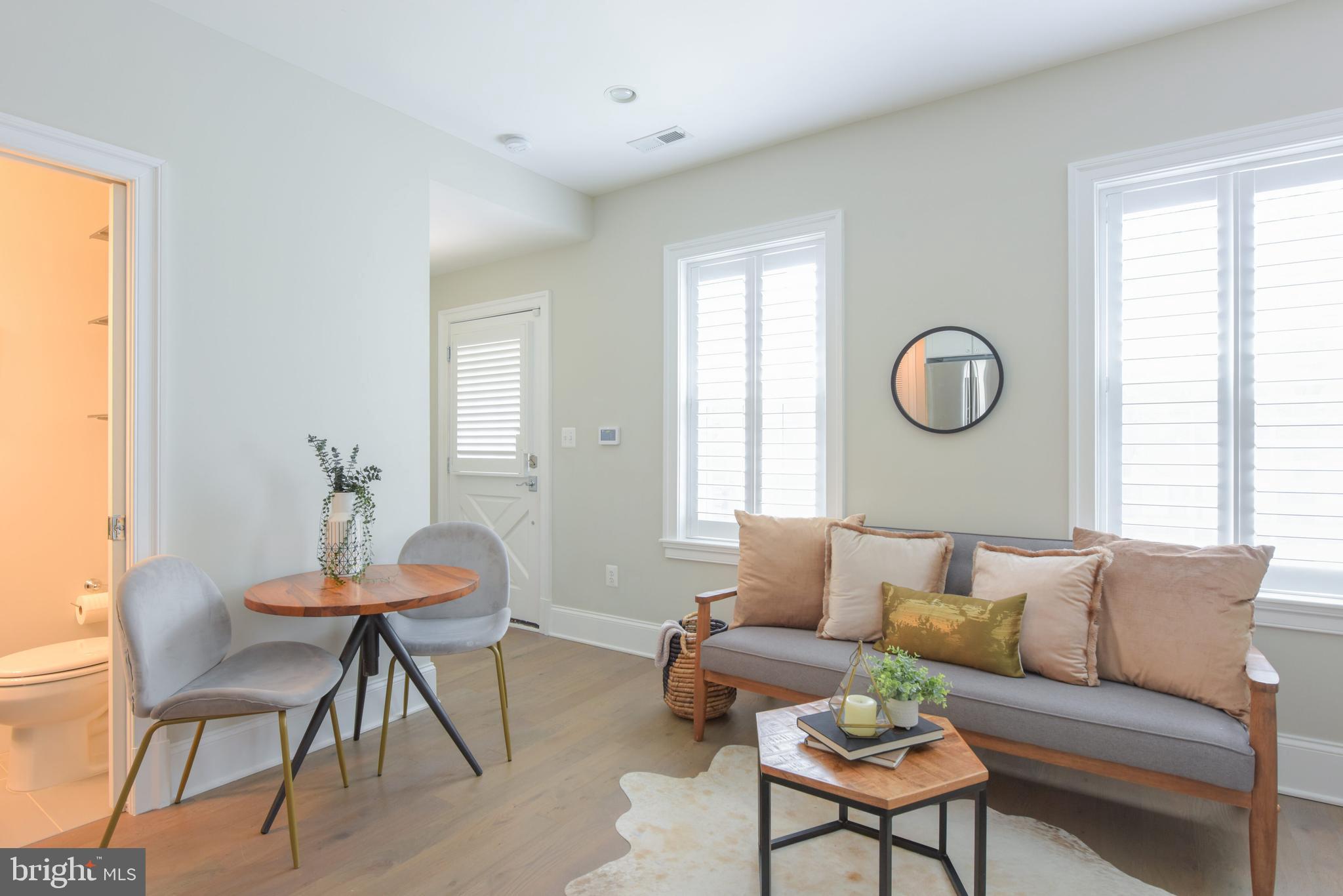 3921 Fulton Street Northwest, Unit 3 Washington, DC 20007 - Photo 4 of 24 a living room with furniture and a window