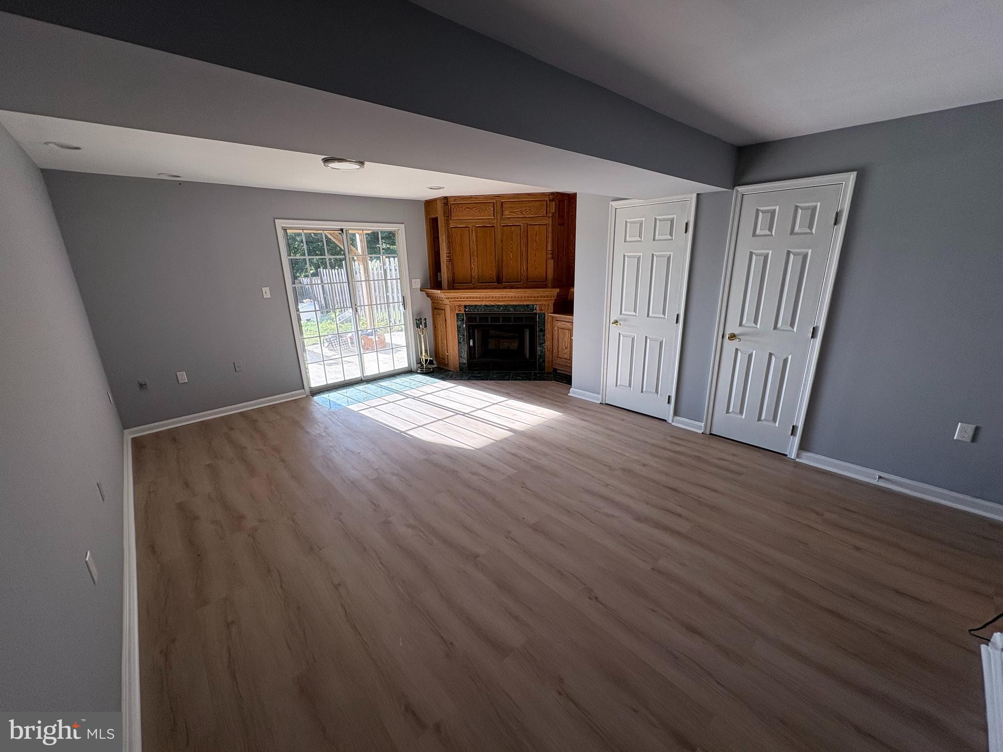4211 Chapelgate Place Belcamp, MD 21017 - Photo 15 of 20 an empty room with wooden floor fireplace and windows