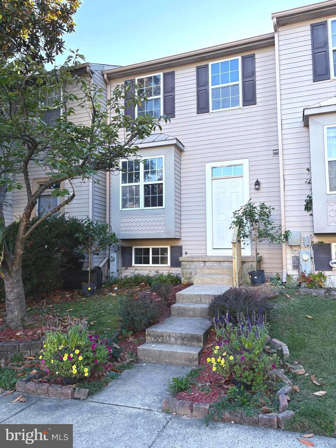 4211 Chapelgate Place Belcamp, MD 21017 - Photo 2 of 20 a front view of a house with a yard and a garden