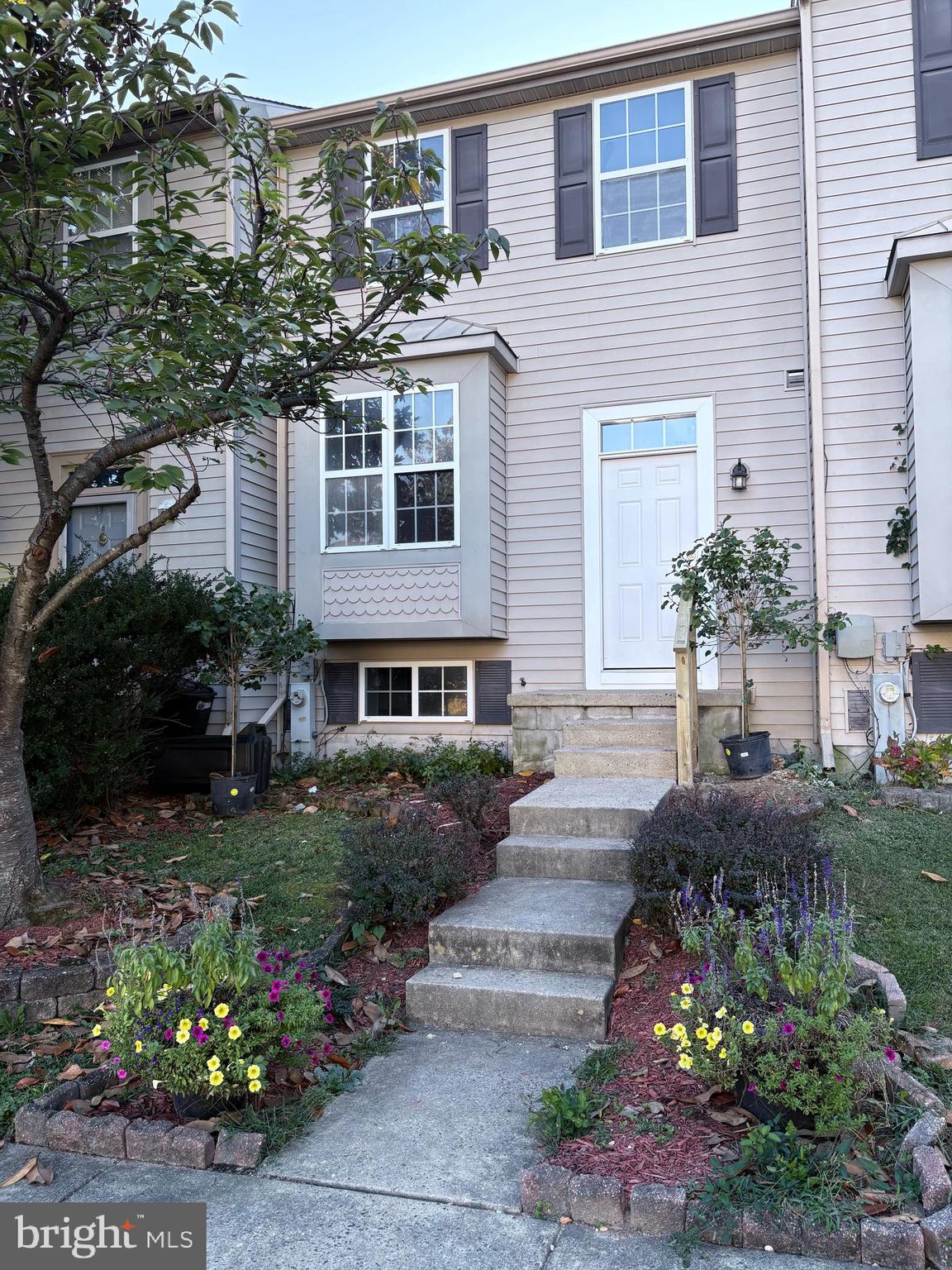 4211 Chapelgate Place Belcamp, MD 21017 - Photo 3 of 20 a front view of a house with a yard and a garden