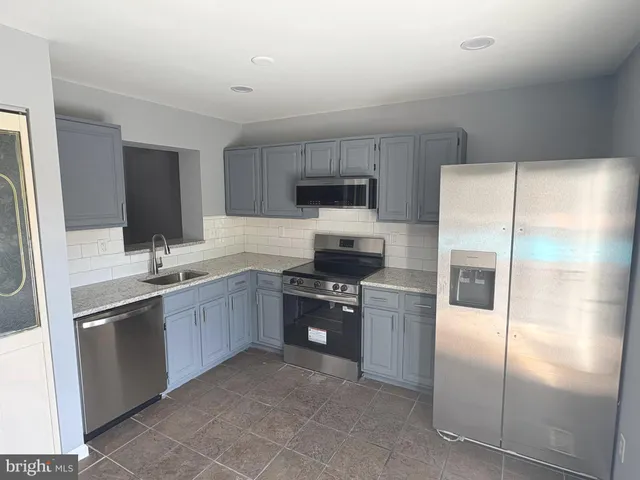 a kitchen with a refrigerator sink and microwave