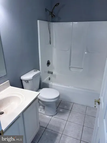 a white toilet sitting next to a bath tub