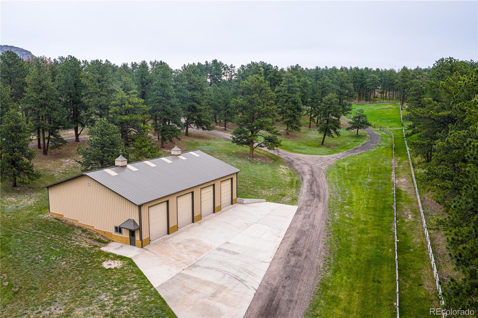 3282 Tomah Road Larkspur, CO 80118 - Photo 5 of 35 a view of a house with pool and a yard
