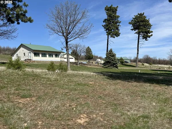 a view of a lake with a house in the background