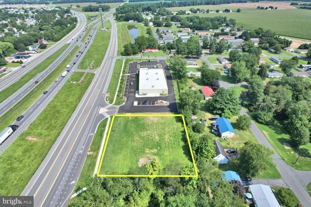 an aerial view of a residential houses with outdoor space and a lake view
