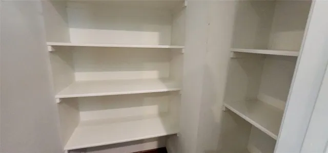 a view of an empty room with windows