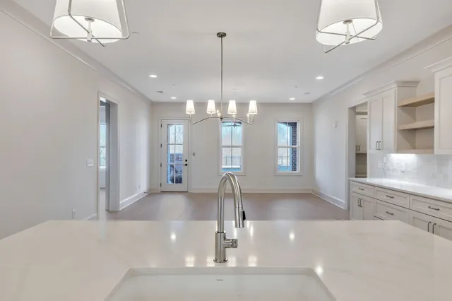 a large kitchen with kitchen island a sink stainless steel appliances and cabinets