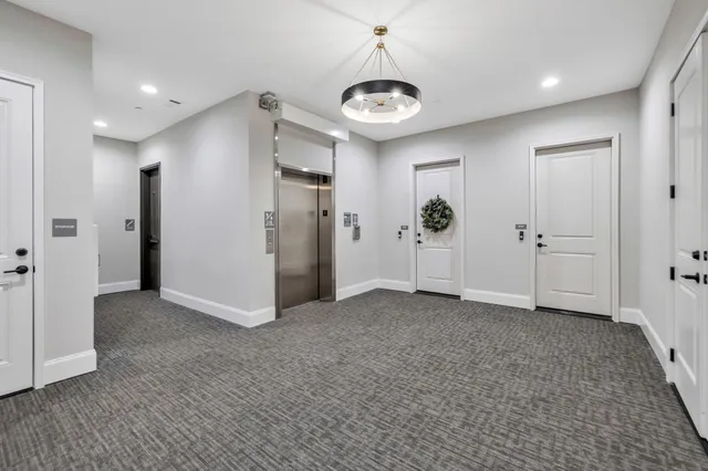 a front view of a house with yard and mountain view in back