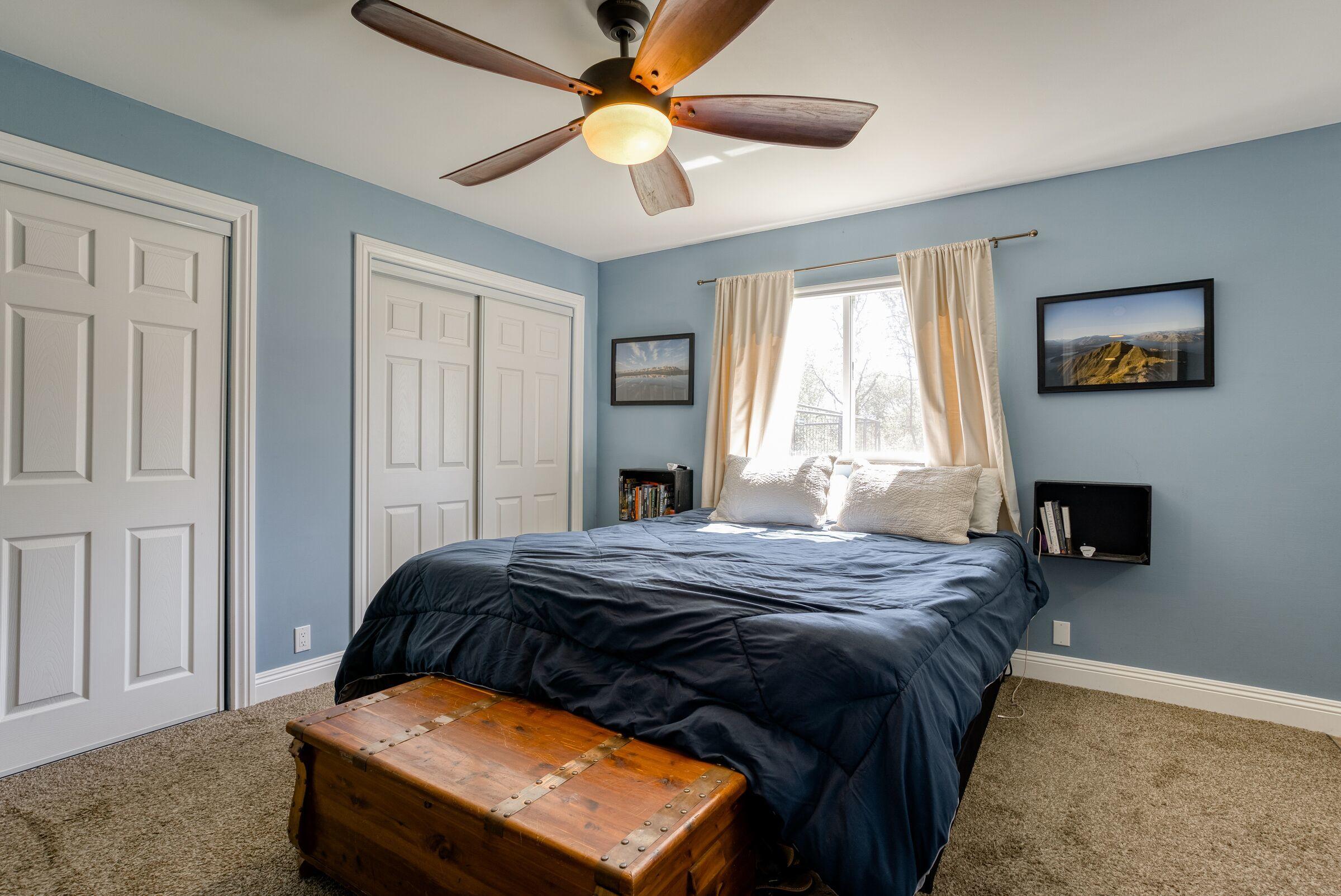 1209 Woodside Meadows Road Redding, CA 96002 - Photo 14 of 22 a bedroom with a bed and a fireplace