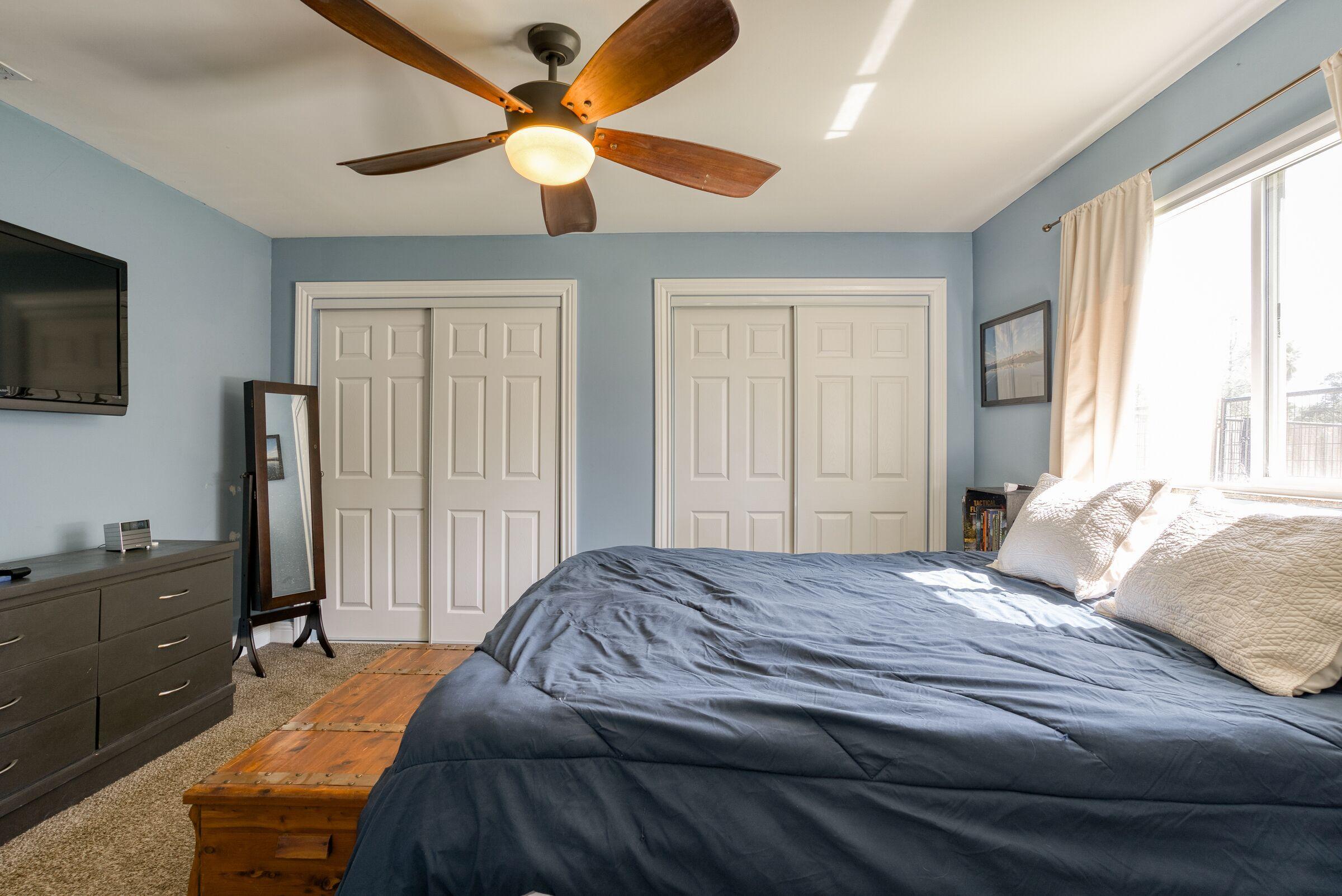 1209 Woodside Meadows Road Redding, CA 96002 - Photo 15 of 22 a bedroom with a bed and a flat tv screen on dresser