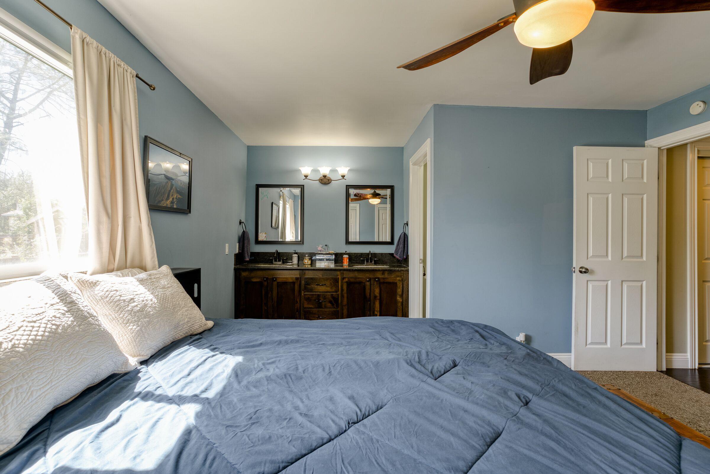 1209 Woodside Meadows Road Redding, CA 96002 - Photo 16 of 22 a bedroom with a bed and a television