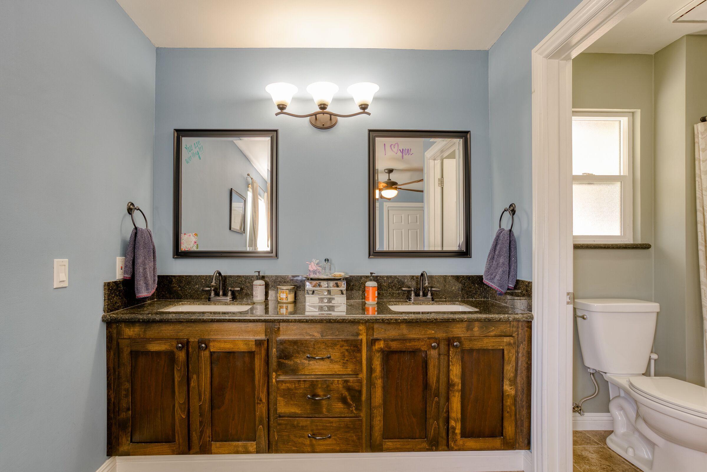 1209 Woodside Meadows Road Redding, CA 96002 - Photo 17 of 22 a bathroom with double vanity two mirror and a toilet