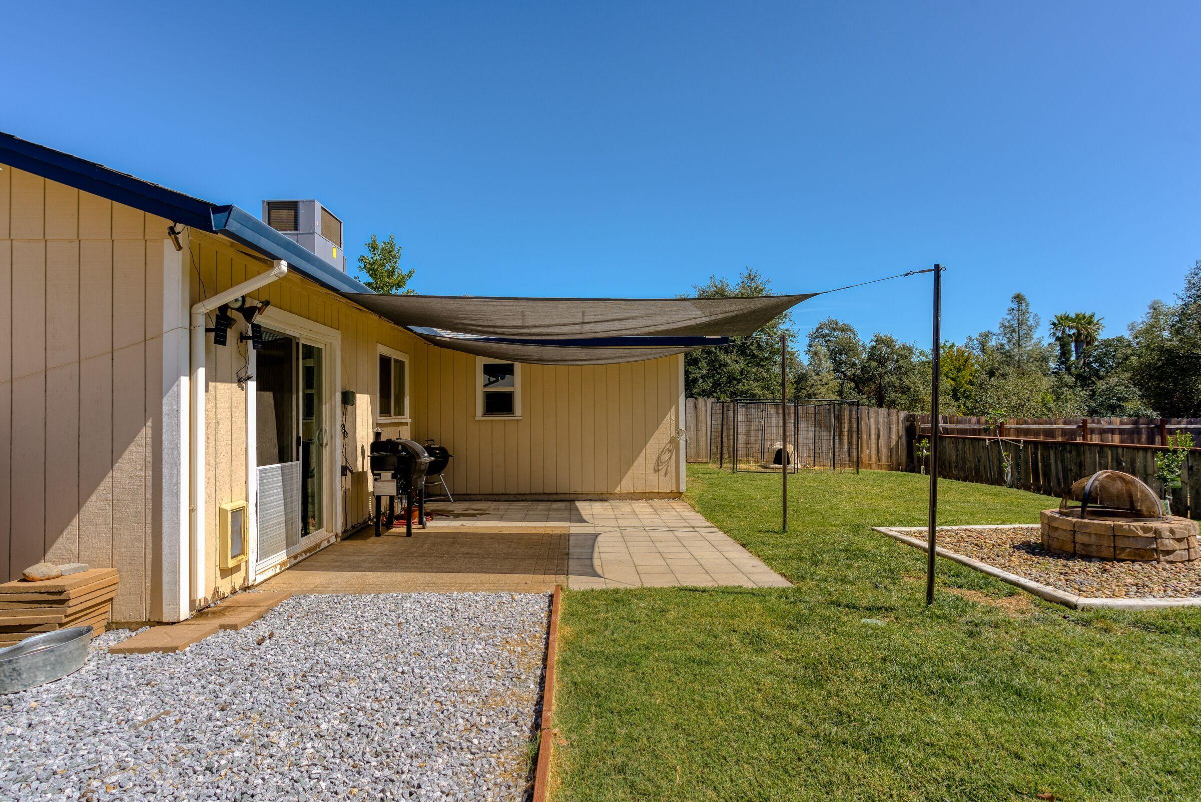 1209 Woodside Meadows Road Redding, CA 96002 - Photo 19 of 22 a view of a house with backyard and trees