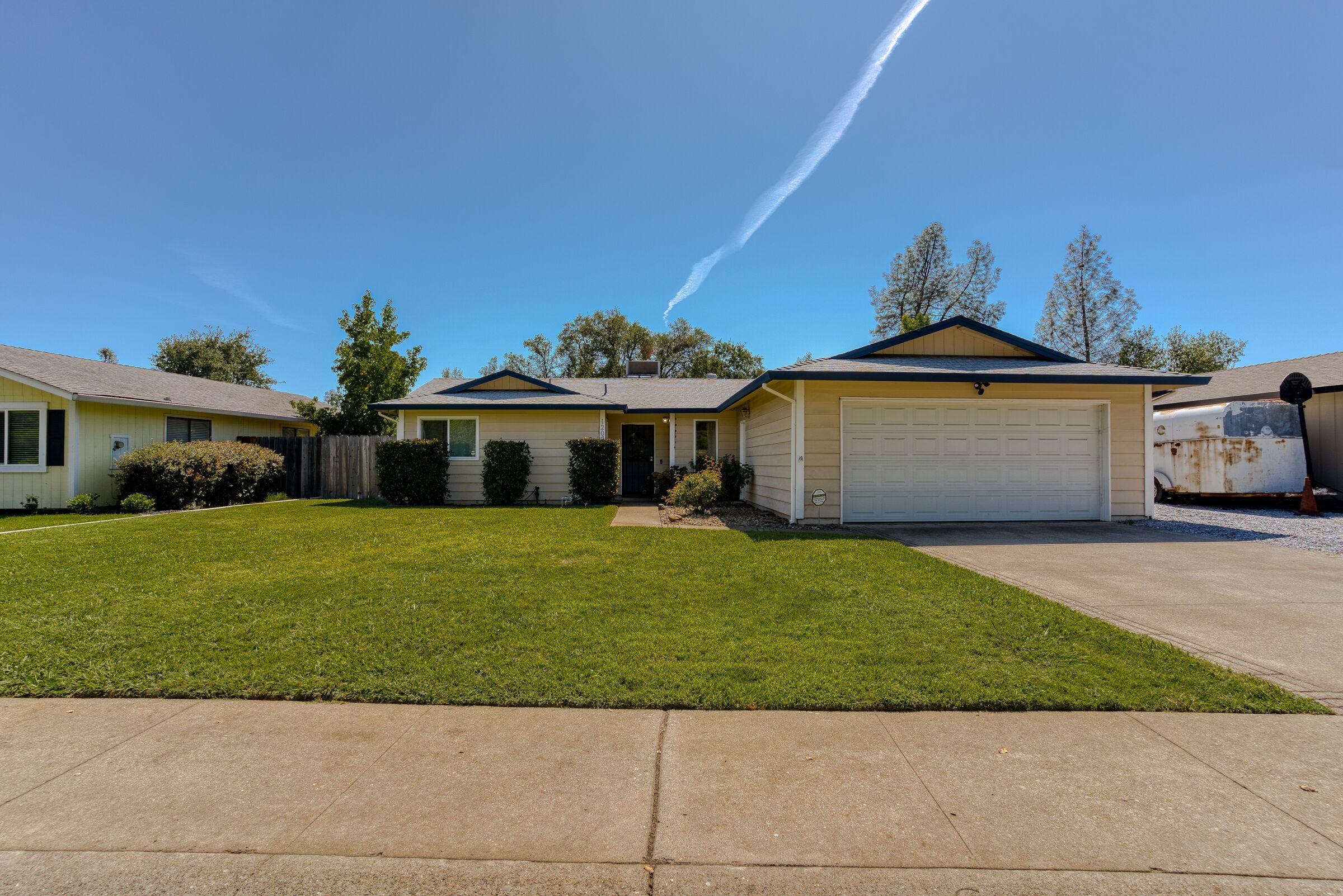 1209 Woodside Meadows Road Redding, CA 96002 - Photo 2 of 22 a front view of a house with a garden