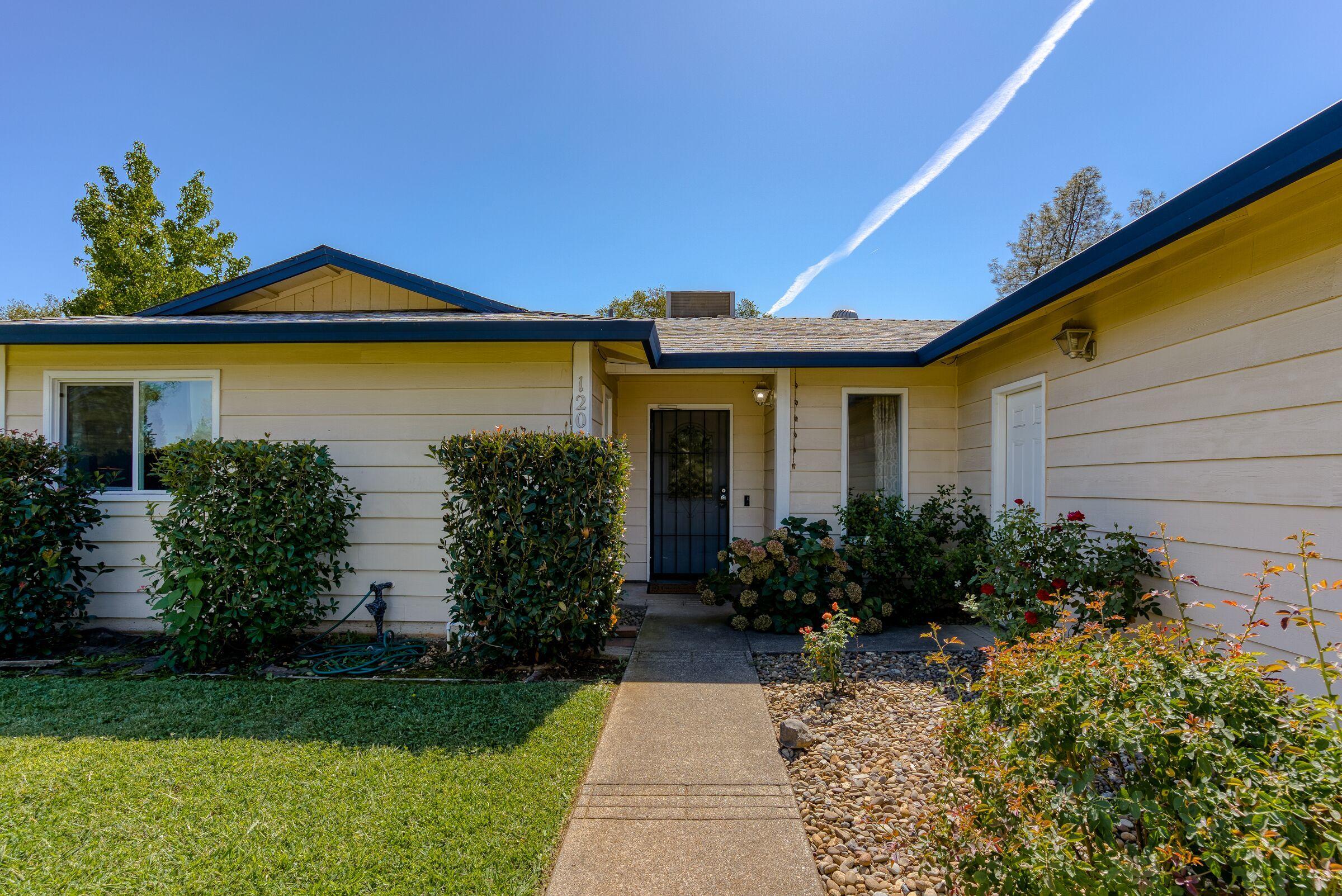 1209 Woodside Meadows Road Redding, CA 96002 - Photo 3 of 22 a front view of a house with garden