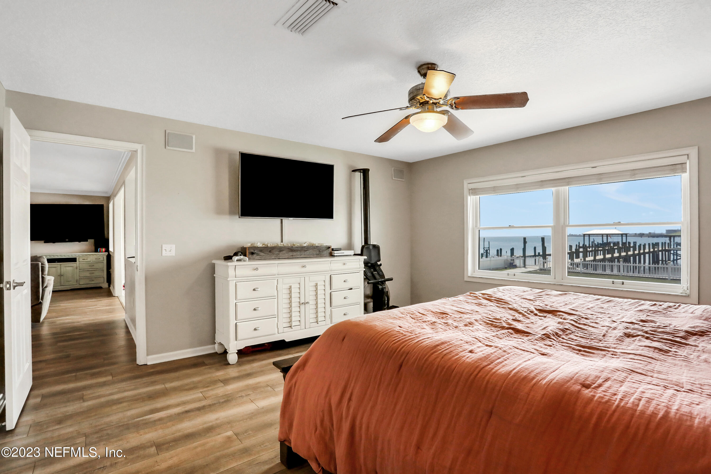 10100 Heckscher Drive Jacksonville, FL 32226 - Photo 23 of 90 a bedroom with a large bed and a flat tv screen