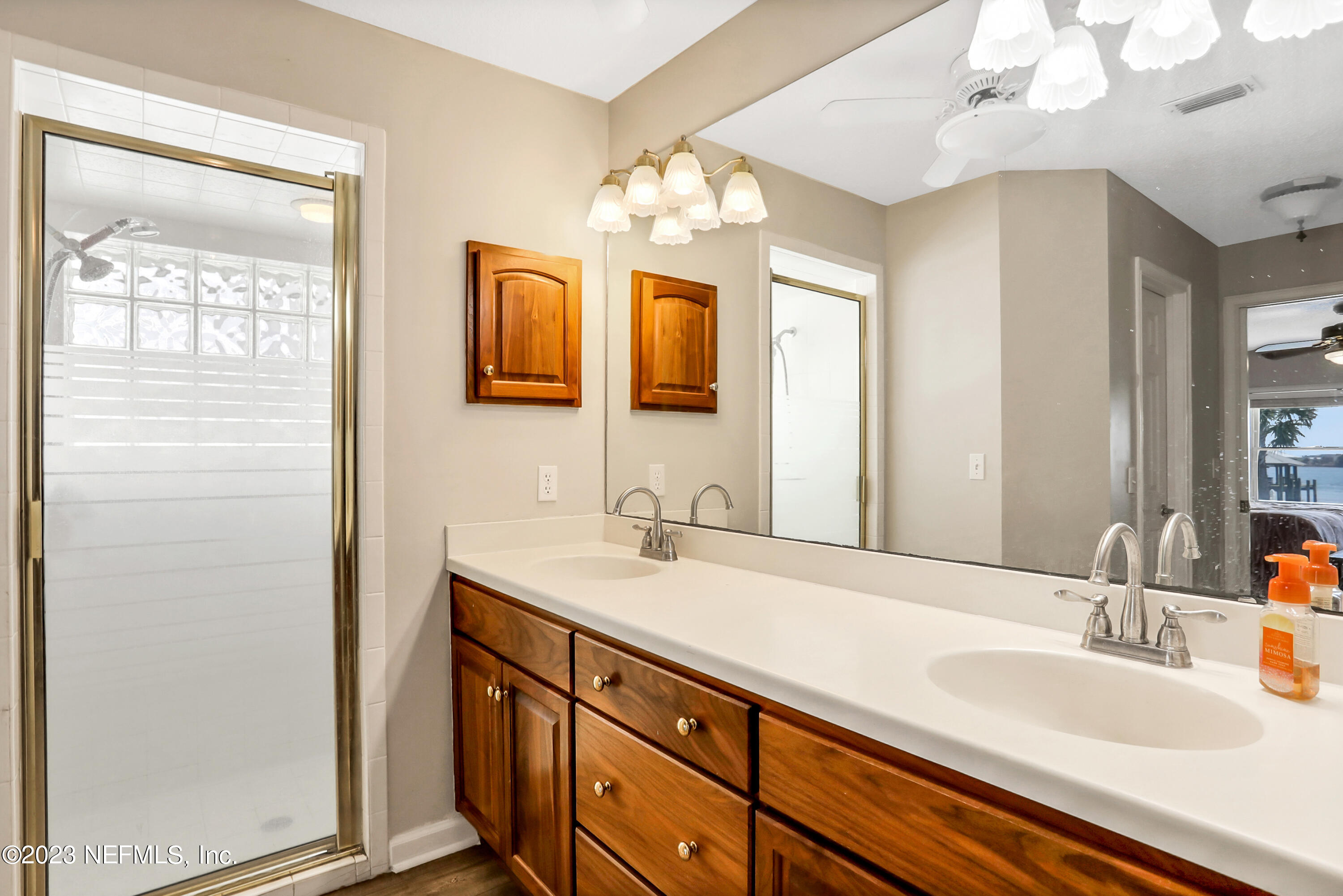 10100 Heckscher Drive Jacksonville, FL 32226 - Photo 24 of 90 a bathroom with a double vanity sink and a mirror