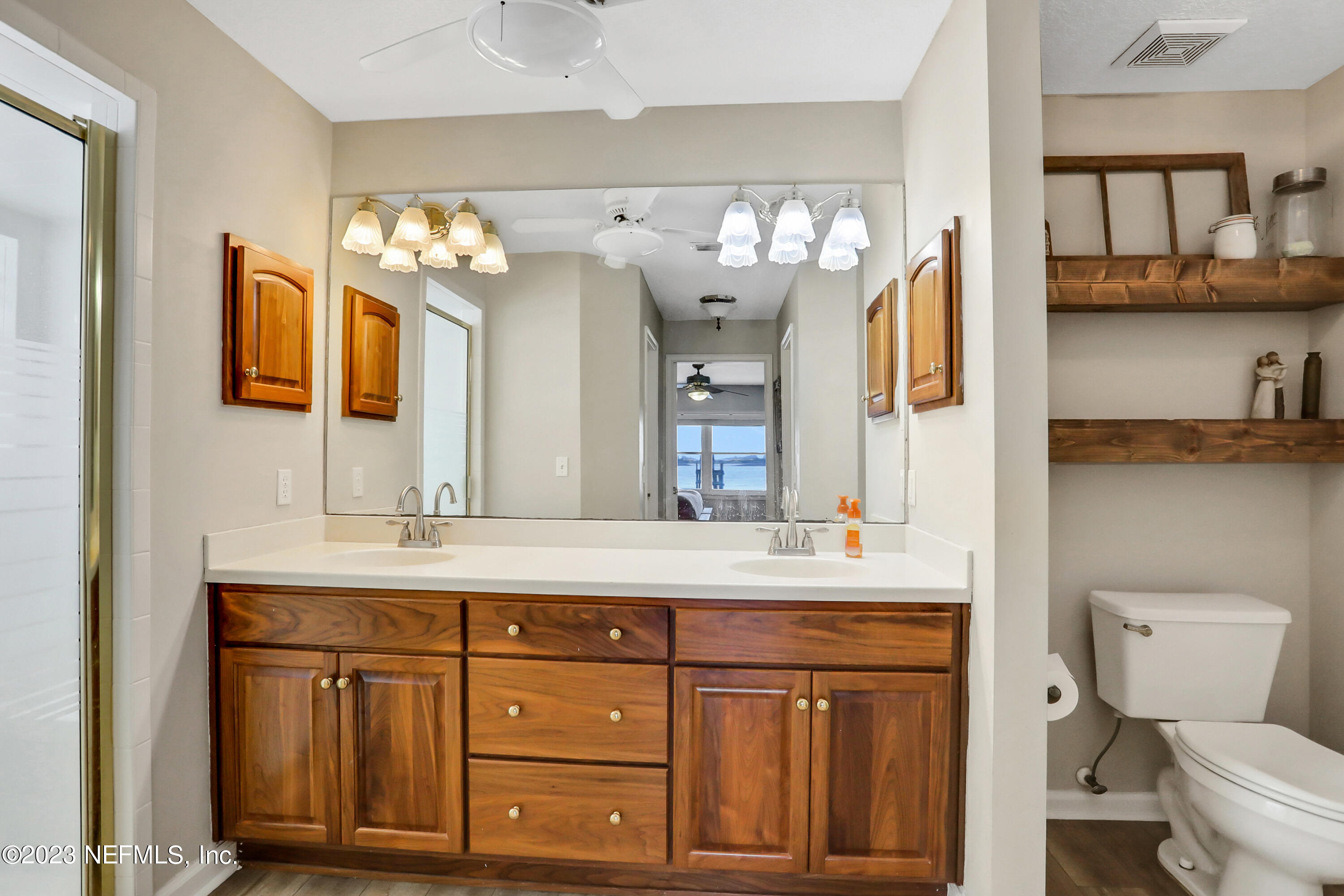 10100 Heckscher Drive Jacksonville, FL 32226 - Photo 25 of 90 a bathroom with a granite countertop sink a toilet and a mirror