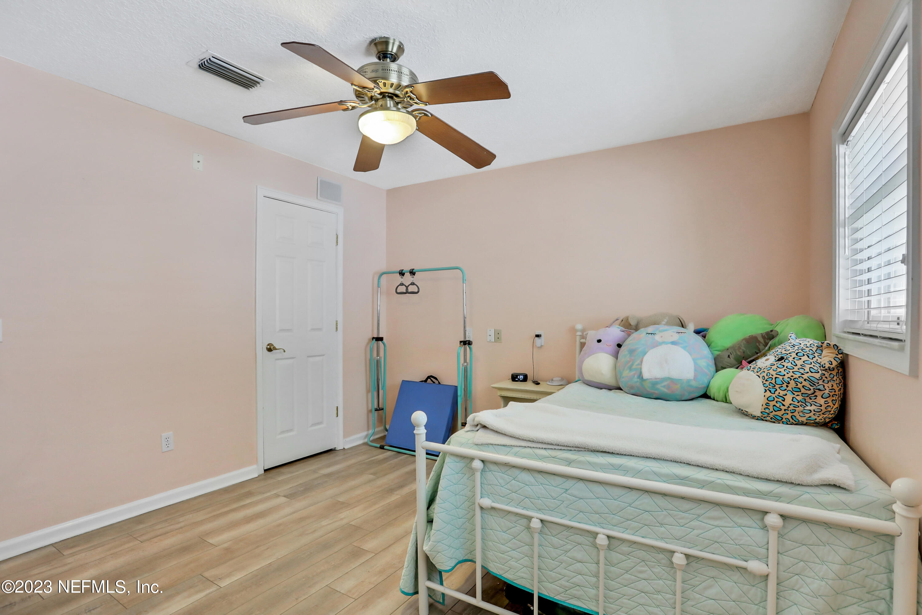 10100 Heckscher Drive Jacksonville, FL 32226 - Photo 32 of 90 a bedroom with a bed chandelier and a window